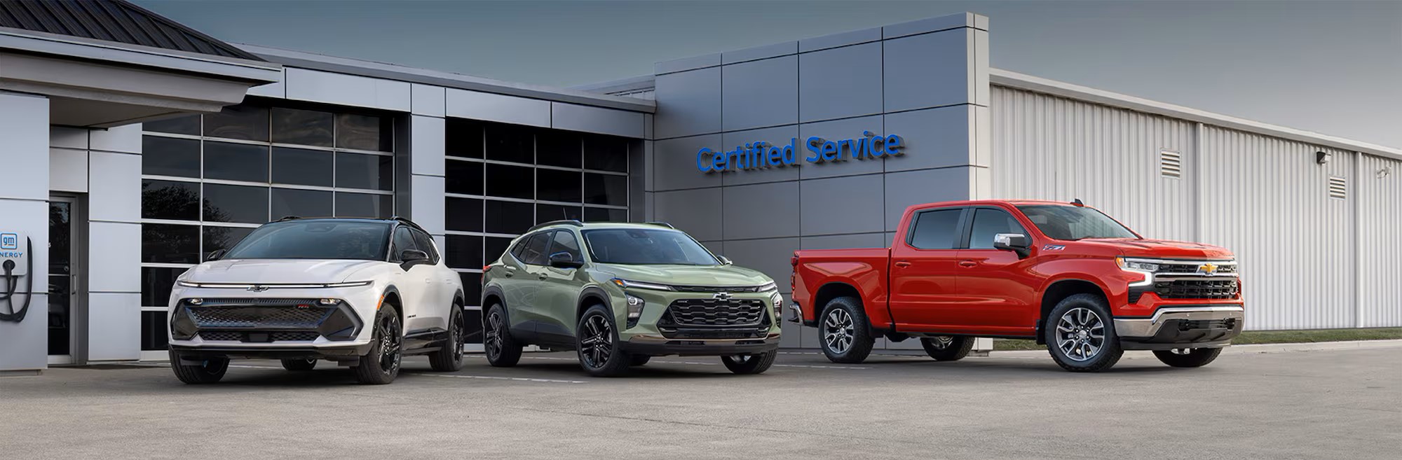 Chevy Certified Service Center with three Chevy Cars Out Front
